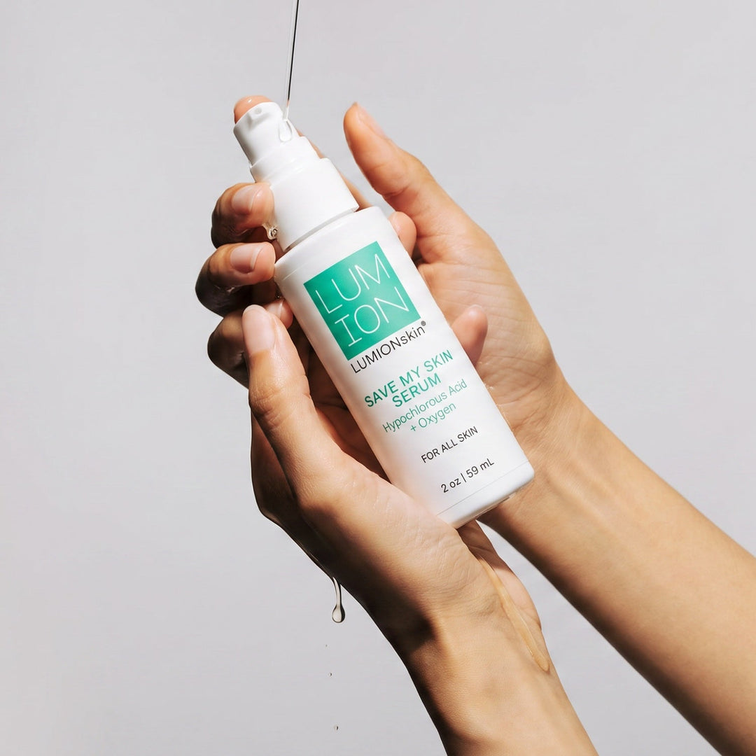 Hands holding a bottle of LUMION skin Save My Skin Serum 