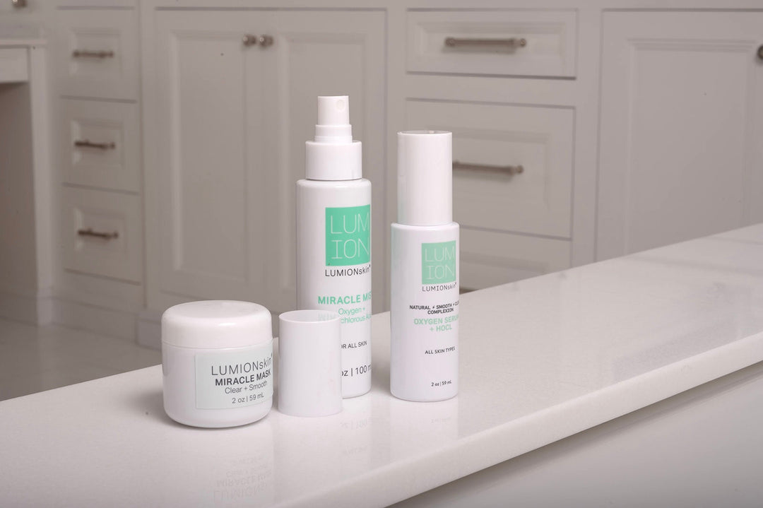 LUMION's hypochlorous acid skincare products - Miracle Mist, Save My Skin Serum and Miracle Mask - on a bathroom vanity. 
