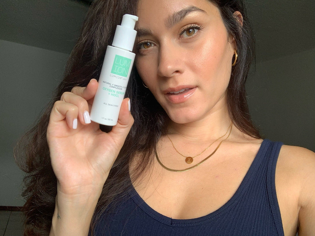 Women holding LUMION's HOCl skincare serum 